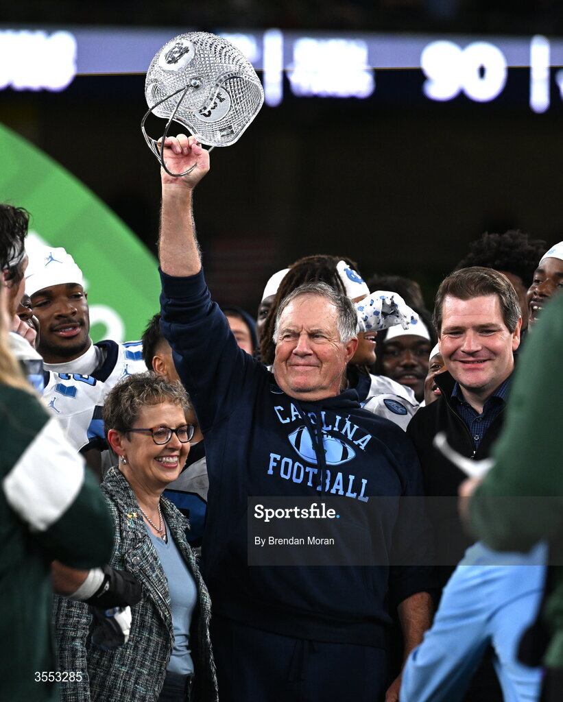 29 August 2026; Aer Lingus chief executive officer Lynne Embleton and Minister for Enterprise, Tourism and Employment Peter Burke TD present the coaches award to North Carolina Head Coach Bill Belichick at the 2026 Aer Lingus College Football Classic match between TCU and North Carolina at the Aviva Stadium in Dublin. Photo by Brendan Moran/Sportsfile
