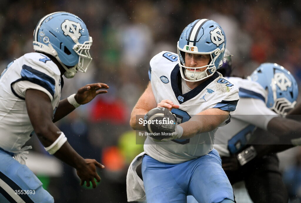 29 August 2026; North Carolina quarterback Billy Edwards Jr #9 hands off the ball to running back Benjamin Hall #7 during the 2026 Aer Lingus College Football Classic match between TCU and North Carolina at the Aviva Stadium in Dublin. Photo by Brendan Moran/Sportsfile