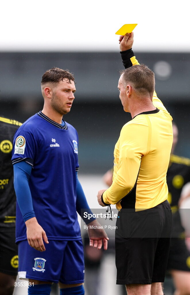 29 August 2026; Ethan Mills of Newbridge Town is shown a yellow card by referee Patrick Sinnott during the FAI National League Group 3 match between CK United and Newbridge Town at SETU Sports Complex in Carlow. Photo by Michael P Ryan/Sportsfile