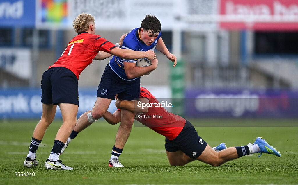 30 August 2026; Tom Martin of Leinster in action against Cillian O'Flynn, left, and Cathal O'Mara of Munster during the PwC U19 InterProvincial Championship match between Leinster and Munster at Energia Park in Dublin. Photo by Tyler Miller/Sportsfile