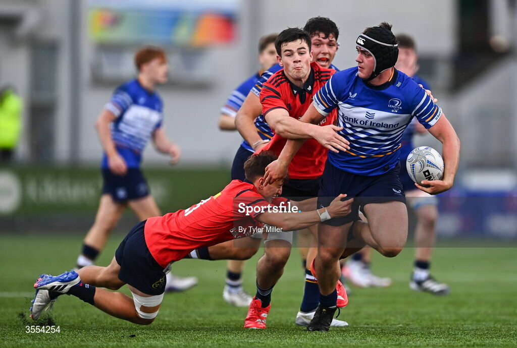 30 August 2026; Eoghan Brady of Leinster in action against Alex Ryan, centre, and Liam O'Brien of Munster during the PwC U19 InterProvincial Championship match between Leinster and Munster at Energia Park in Dublin. Photo by Tyler Miller/Sportsfile