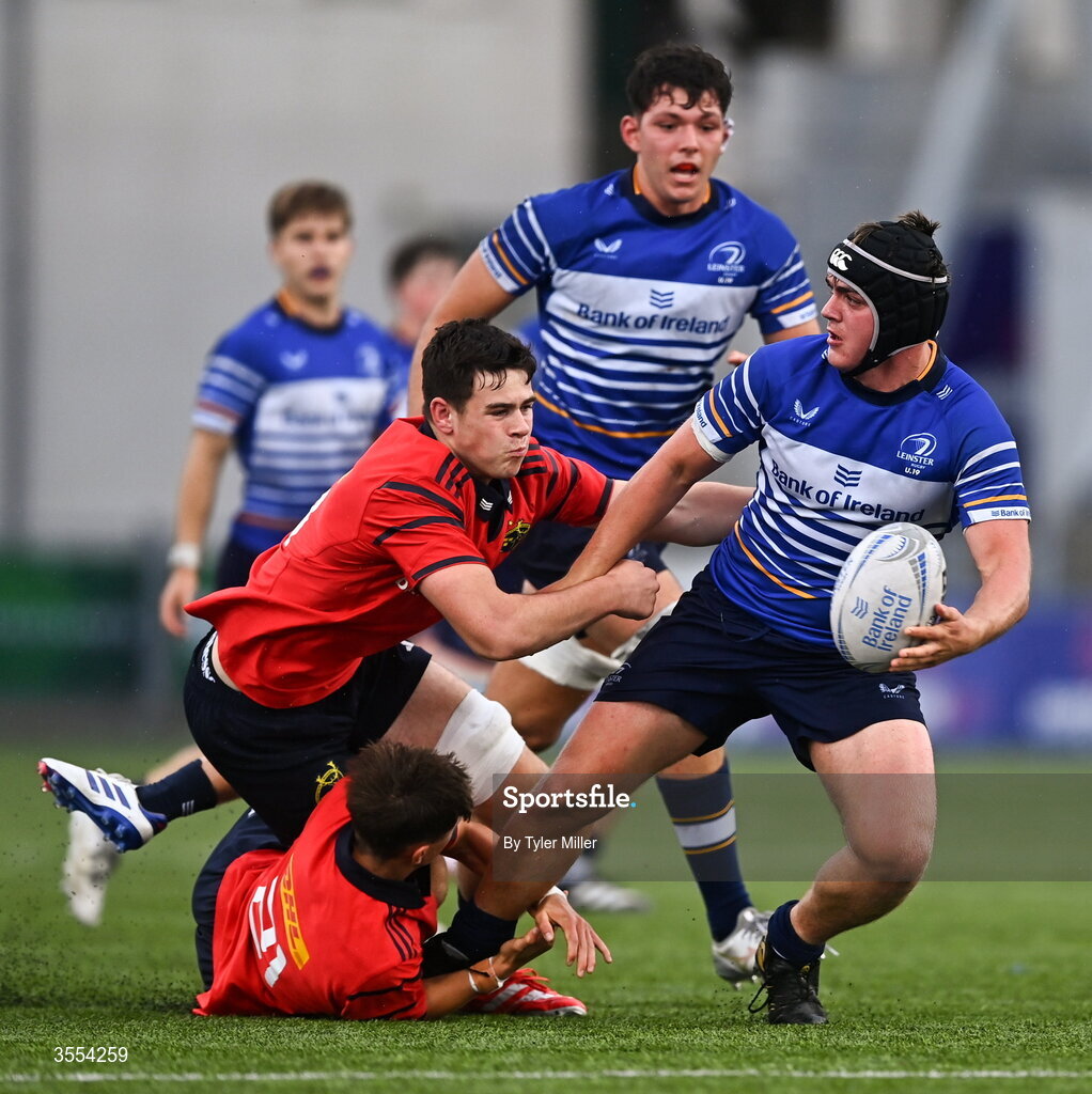 30 August 2026; Eoghan Brady of Leinster in action against Alex Ryan, centre, and Liam O'Brien of Munster during the PwC U19 InterProvincial Championship match between Leinster and Munster at Energia Park in Dublin. Photo by Tyler Miller/Sportsfile
