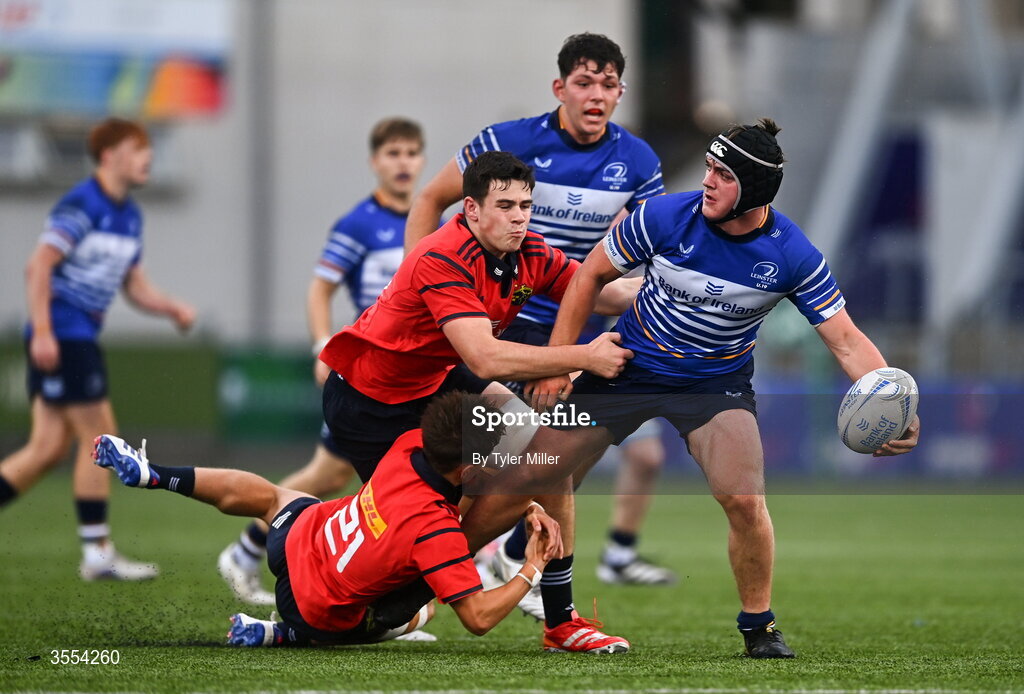 30 August 2026; Eoghan Brady of Leinster in action against Alex Ryan, centre, and Liam O'Brien of Munster during the PwC U19 InterProvincial Championship match between Leinster and Munster at Energia Park in Dublin. Photo by Tyler Miller/Sportsfile