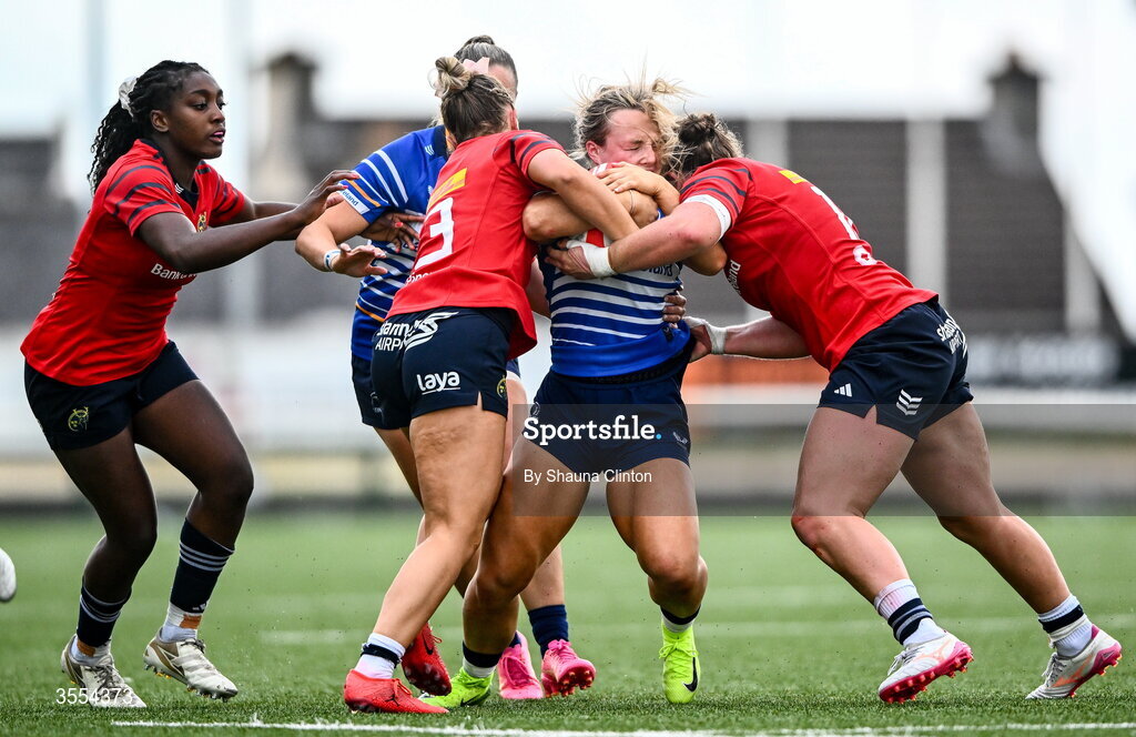 29 August 2026; Aoife Dalton of Leinster is tackled by Munster players Lucia Linn, left, and Enya Breen during the Vodafone Womens Interprovincial Championship final match between Munster and Leinster at Dexcom Stadium in Galway. Photo by Shauna Clinton/Sportsfile