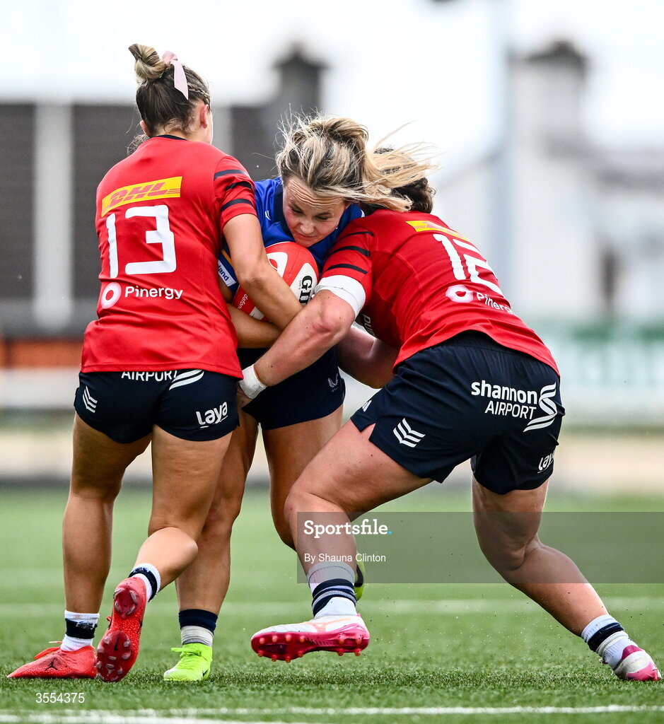 29 August 2026; Aoife Dalton of Leinster is tackled by Munster players Lucia Linn, left, and Enya Breen during the Vodafone Womens Interprovincial Championship final match between Munster and Leinster at Dexcom Stadium in Galway. Photo by Shauna Clinton/Sportsfile