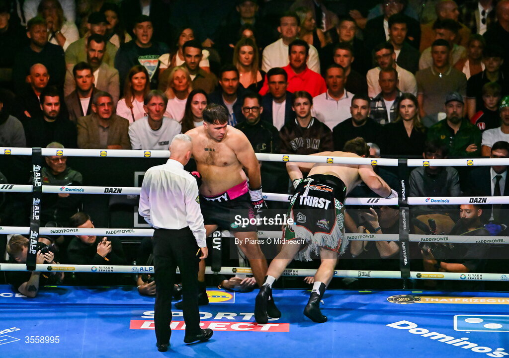 5 September 2026; Thomas Carty is knocked through the ropes by Dave Allen during their heavyweight bout at the Once Upon A Time fight night in Croke Park, Dublin. Photo by Piaras Ó Mídheach/Sportsfile