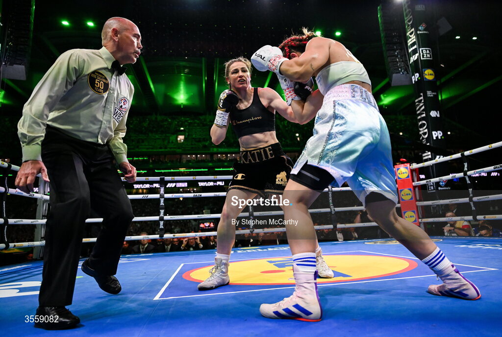 5 September 2026; Katie Taylor, centre, and Flora Pili, watched by referee referee David Irving, during their undisputed super lightweight championship fight at the Once Upon A Time fight night in Croke Park, Dublin. Photo by Stephen McCarthy/Sportsfile