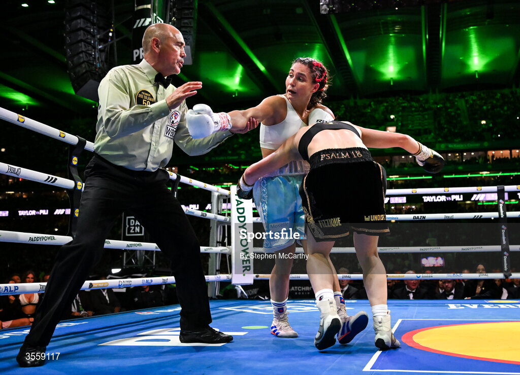 5 September 2026; Katie Taylor, right, and Flora Pili as Referee David Irving watches on during their undisputed super lightweight championship fight at the Once Upon A Time fight night in Croke Park, Dublin. Photo by Stephen McCarthy/Sportsfile