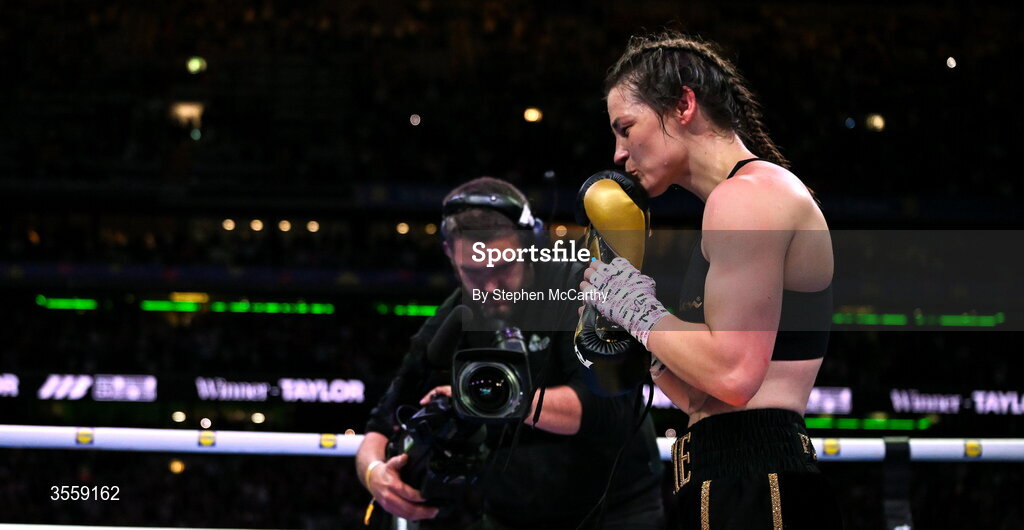 5 September 2026; Katie Taylor places her gloves onto the centre of the ring after her undisputed super lightweight championship fight with Flora Pili at the Once Upon A Time fight night in Croke Park, Dublin. Photo by Stephen McCarthy/Sportsfile