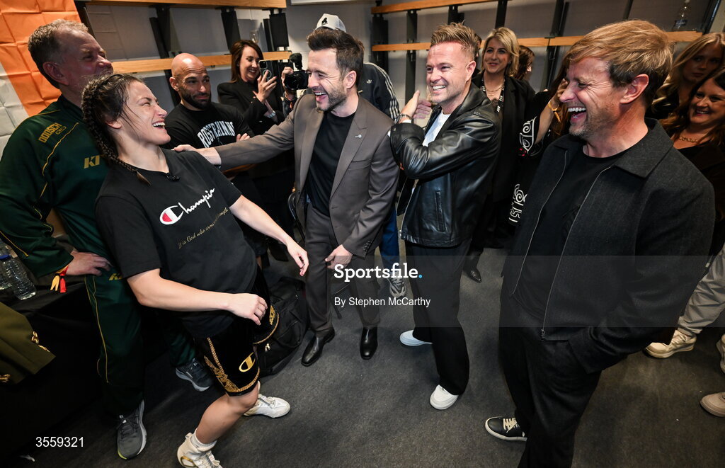 5 September 2026; Katie Taylor in her dressing room, with members of Westlife, from left, Shane Filan, Nicky Byrne and Kian Egan following her undisputed super lightweight championship fight victory over Flora Pili at the Once Upon A Time fight night in Croke Park, Dublin. Photo by Stephen McCarthy/Sportsfile