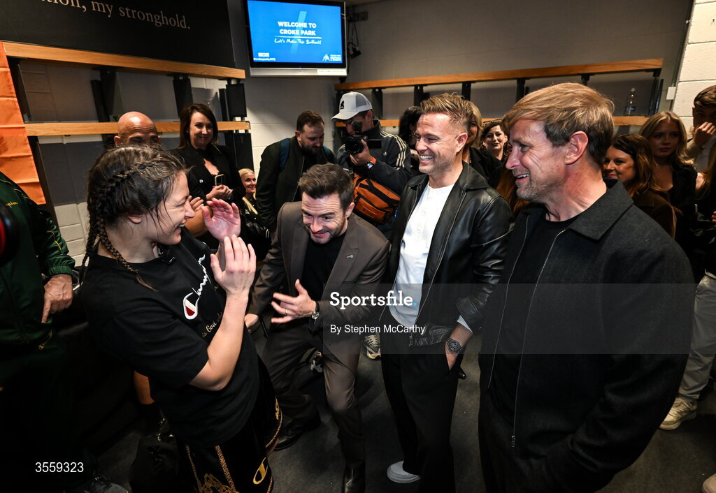 5 September 2026; Katie Taylor in her dressing room, with members of Westlife, from left, Shane Filan, Nicky Byrne and Kian Egan following her undisputed super lightweight championship fight victory over Flora Pili at the Once Upon A Time fight night in Croke Park, Dublin. Photo by Stephen McCarthy/Sportsfile