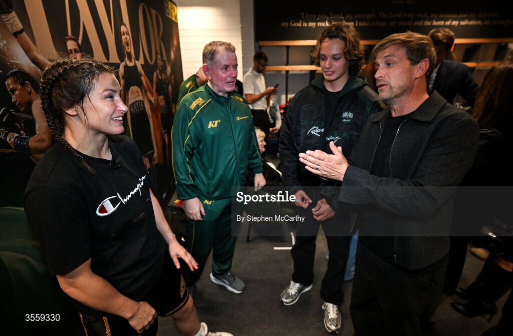 5 September 2026; Katie Taylor in her dressing room with manager Brian Peters and Kian Egan of Westlife and his son Koa following her undisputed super lightweight championship fight victory over Flora Pili at the Once Upon A Time fight night in Croke Park, Dublin. Photo by Stephen McCarthy/Sportsfile