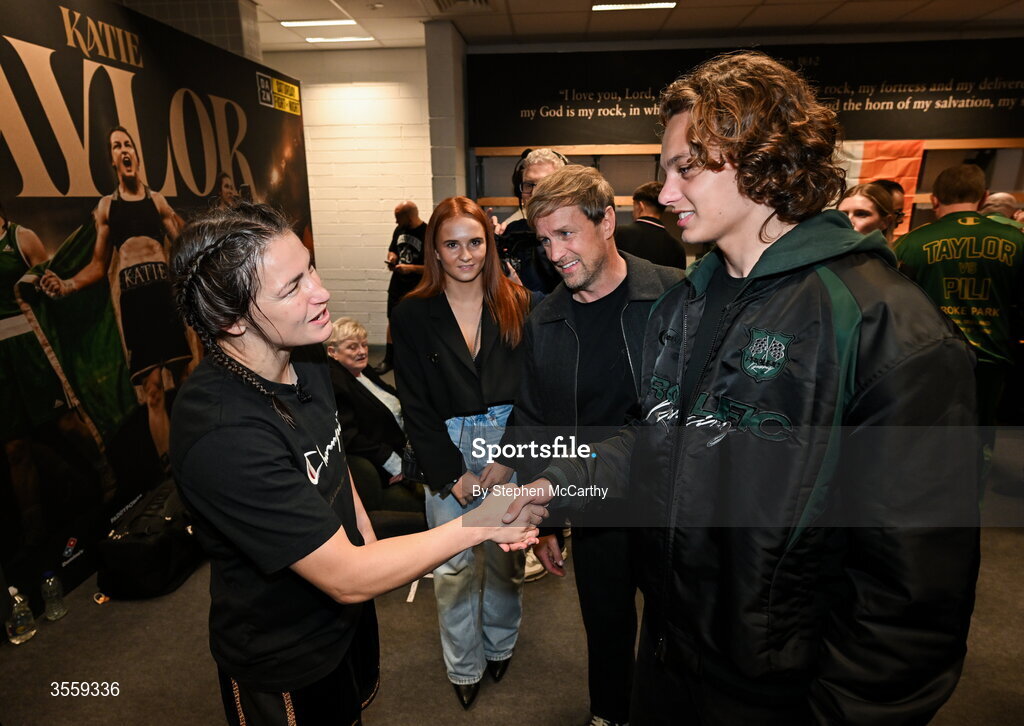 5 September 2026; Katie Taylor in her dressing room with Westlife's Kian Egan, his son Koa and niece Jersey Fogg, following her undisputed super lightweight championship fight victory over Flora Pili at the Once Upon A Time fight night in Croke Park, Dublin. Photo by Stephen McCarthy/Sportsfile