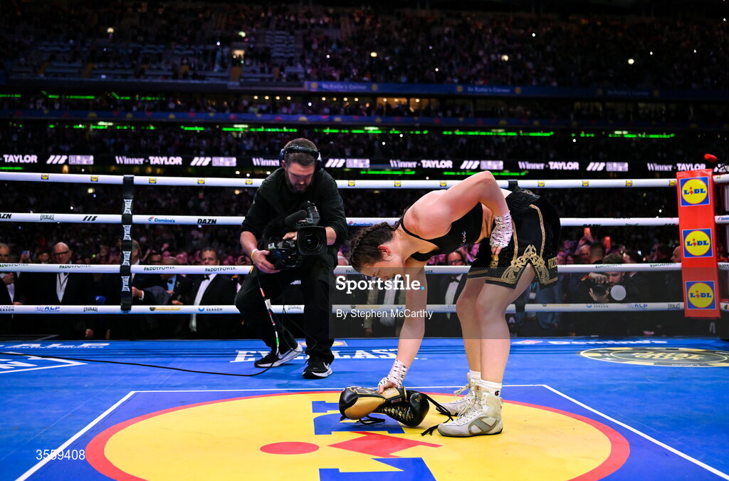5 September 2026; Katie Taylor places her gloves in the centre of the ring following her undisputed super lightweight championship fight victory over Flora Pili at the Once Upon A Time fight night in Croke Park, Dublin. Photo by Stephen McCarthy/Sportsfile