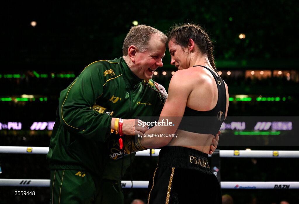 5 September 2026; Katie Taylor has her gloves remover by her manager Brian Peters following her undisputed super lightweight championship fight victory over Flora Pili at the Once Upon A Time fight night in Croke Park, Dublin. Photo by Stephen McCarthy/Sportsfile