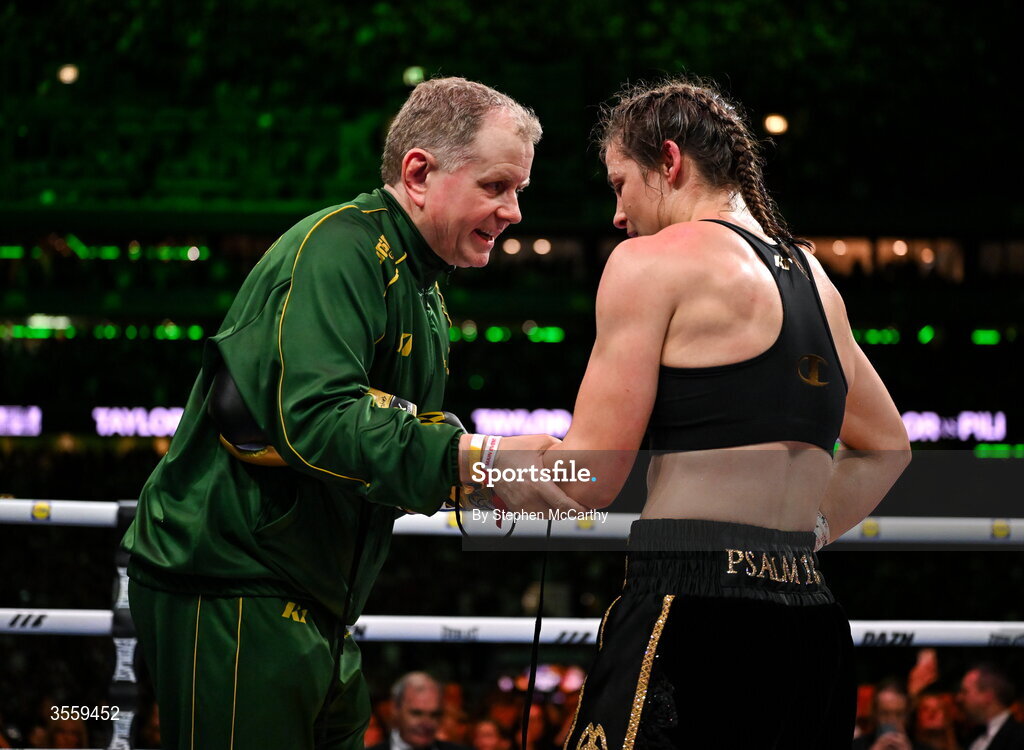 5 September 2026; Katie Taylor has her gloves remover by her manager Brian Peters following her undisputed super lightweight championship fight victory over Flora Pili at the Once Upon A Time fight night in Croke Park, Dublin. Photo by Stephen McCarthy/Sportsfile