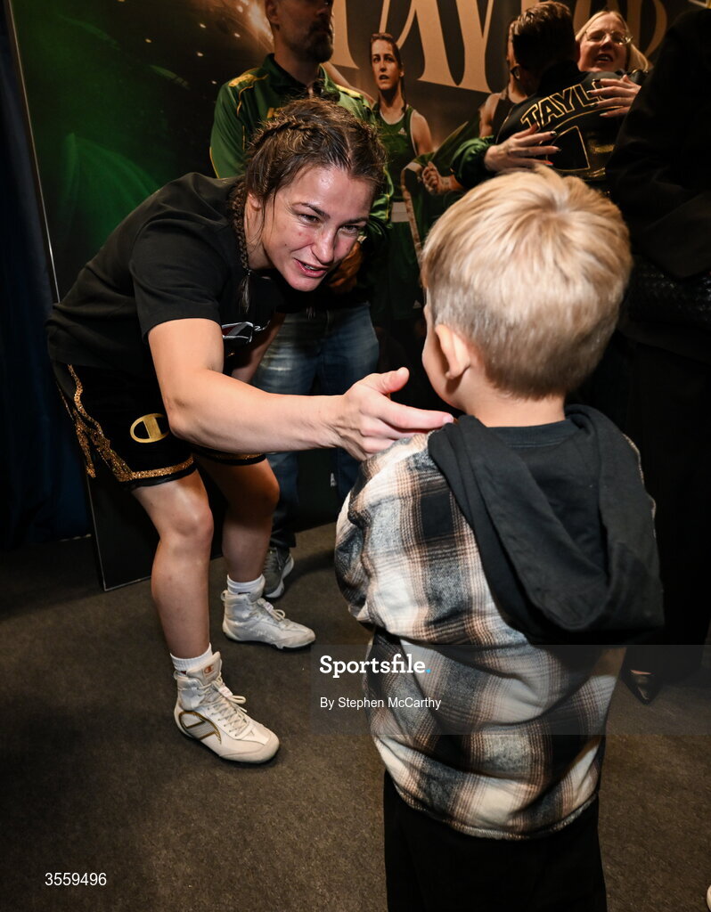 5 September 2026; Katie Taylor with Ian Machado Garry's son Leandro in her dressing room following her undisputed super lightweight championship fight victory over Flora Pili at the Once Upon A Time fight night in Croke Park, Dublin. Photo by Stephen McCarthy/Sportsfile