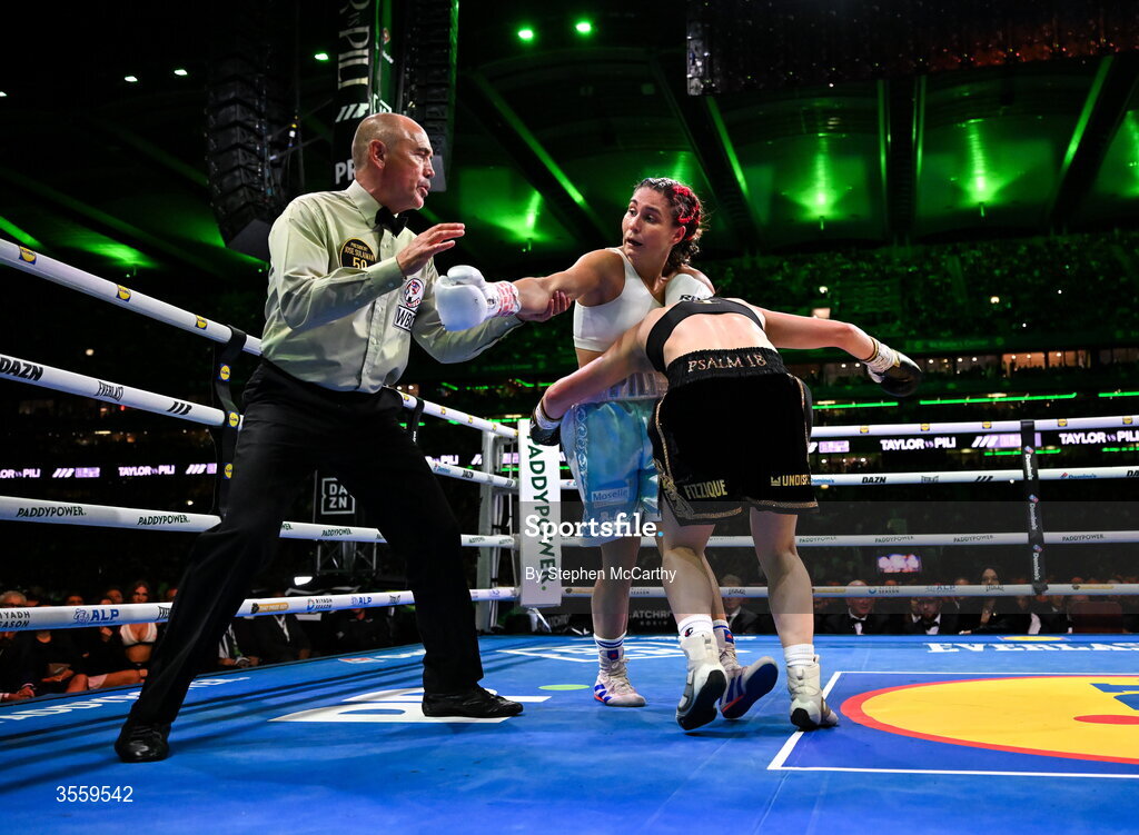 5 September 2026; Katie Taylor, right, and Flora Pili as Referee David Irving watches on during their undisputed super lightweight championship fight at the Once Upon A Time fight night in Croke Park, Dublin. Photo by Stephen McCarthy/Sportsfile