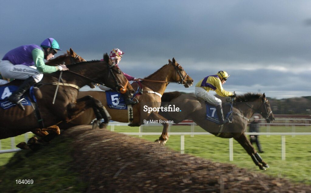 29 December 2004; Strong Project,7, with Paul Carberry up, jumps the first on their way to winning the Coyle Hamilton Willis Beginners Steeplechase also pictured are Skibb with Conor O'Dwyer and In To The Sunset,4, with David Russell. Leopardstown Racecourse, Dublin. Picture credit; Matt Browne / SPORTSFILE