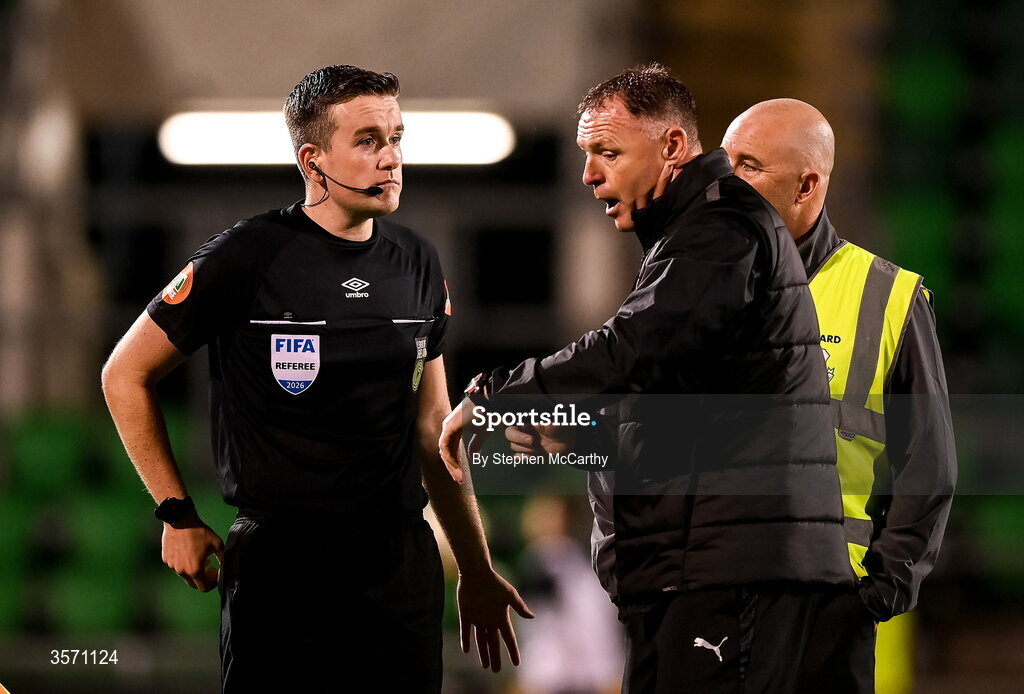 18 September 2026; Waterford first team head coach Graham Coughlan shows his watch to referee Aaron O'Dowd following the SSE Airtricity Men’s Premier Division match between Shamrock Rovers and Waterford at Tallaght Stadium in Dublin. Photo by Stephen McCarthy/Sportsfile
