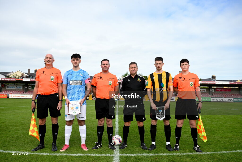 20 September 2026; Team captains Dan Ryan Fortune of St Mary's AFC and David Curran of Cobh Wanderers stand with referees Robert O'Leary, Tom McCarthy, Bobby Coonan, Allan Martin before the 2026 FAI Intermediate Cup Final between Cobh Wanderers and St Mary's at Munster FA Turners Cross Stadium in Cork. Photo by Eakin Howard/Sportsfile