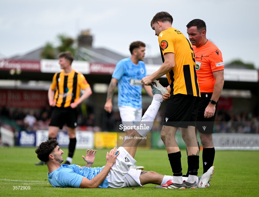 20 September 2026; Ciaran Griffin of Cobh Wanderers helps David Dunphy of St Mary's AFC stretch during the 2026 FAI Intermediate Cup Final between Cobh Wanderers and St Mary's at Munster FA Turners Cross Stadium in Cork. Photo by Eakin Howard/Sportsfile