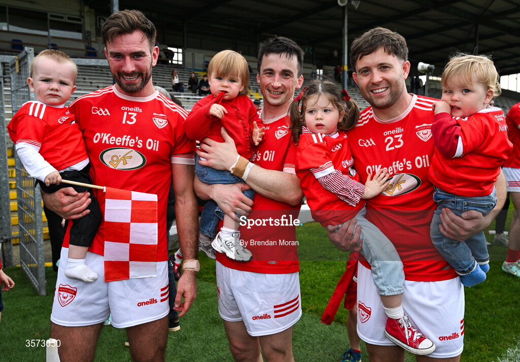20 September 2026; Rathermore players, from left, Brendan O'Keeffe with his son Cian, Paul Murphy and his daughter Lucy, and Mark Reen and his children Ivy and Louis celebrate after the Kerry Senior Club Football Championship Final between Dr Crokes and Rathmore at Fitzgerald Stadium in Killarney, Kerry. Photo by Brendan Moran/Sportsfile
