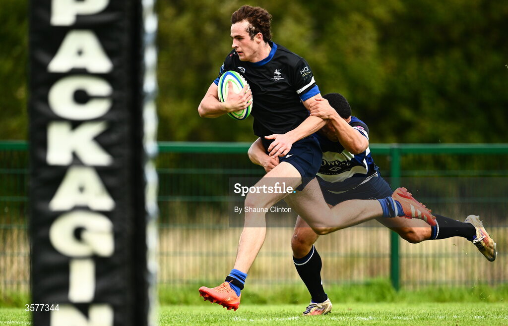 26 September 2026; Ned Williams of Galway Corinthians on his way to scoring his side's first try despite the efforts of Jordan Conroy of Wanderers during the Energia Men's All-Ireland League Division 2A match between Galway Corinthians and Wanderers at Dangan Sportground in Galway. Photo by Shauna Clinton/Sportsfile
