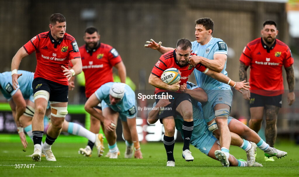 26 September 2026; JJ Hanrahan of Munster is tackled by Patrick Schickerling and Rory Darge of Glasgow Warriors during the United Rugby Championship match between Munster and Glasgow Warriors at Thomond Park in Limerick. Photo by Brendan Moran/Sportsfile