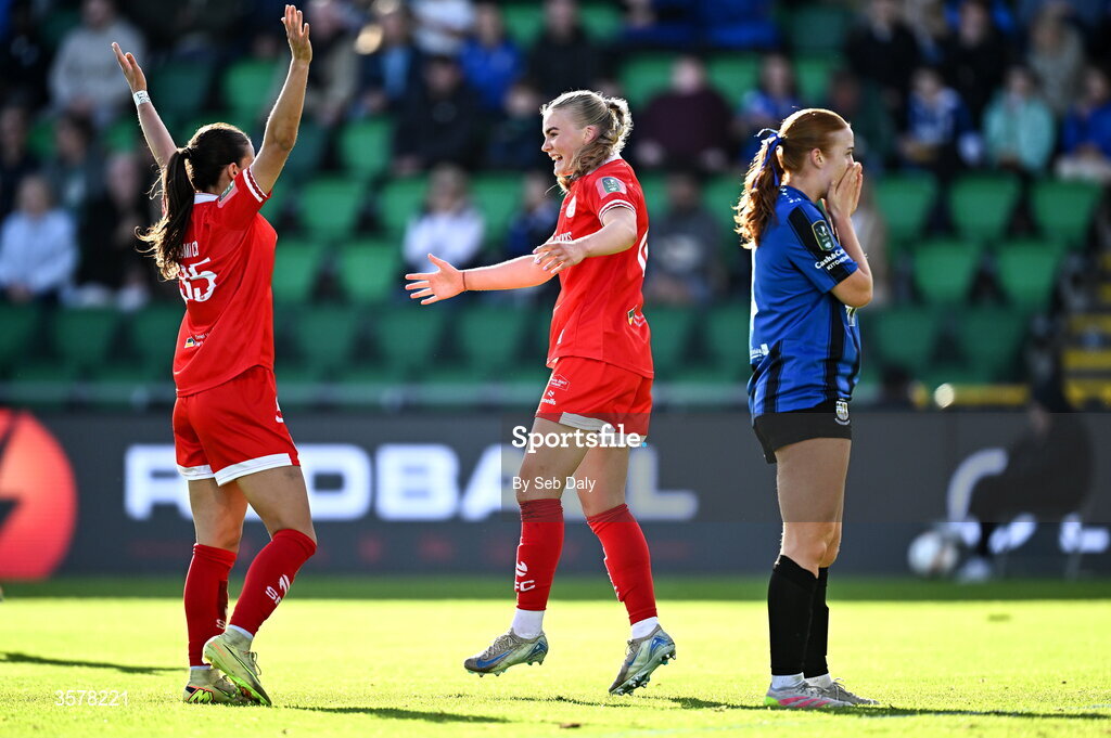 27 September 2026; Maeve Wollmer of Shelbourne, centre, celebrates with teammate Olivia Damico, left, after scoring their side's third goal during the 2026 Club Orange Women's FAI Cup final between Athlone Town and Shelbourne at Tallaght Stadium in Dublin. Photo by Seb Daly/Sportsfile