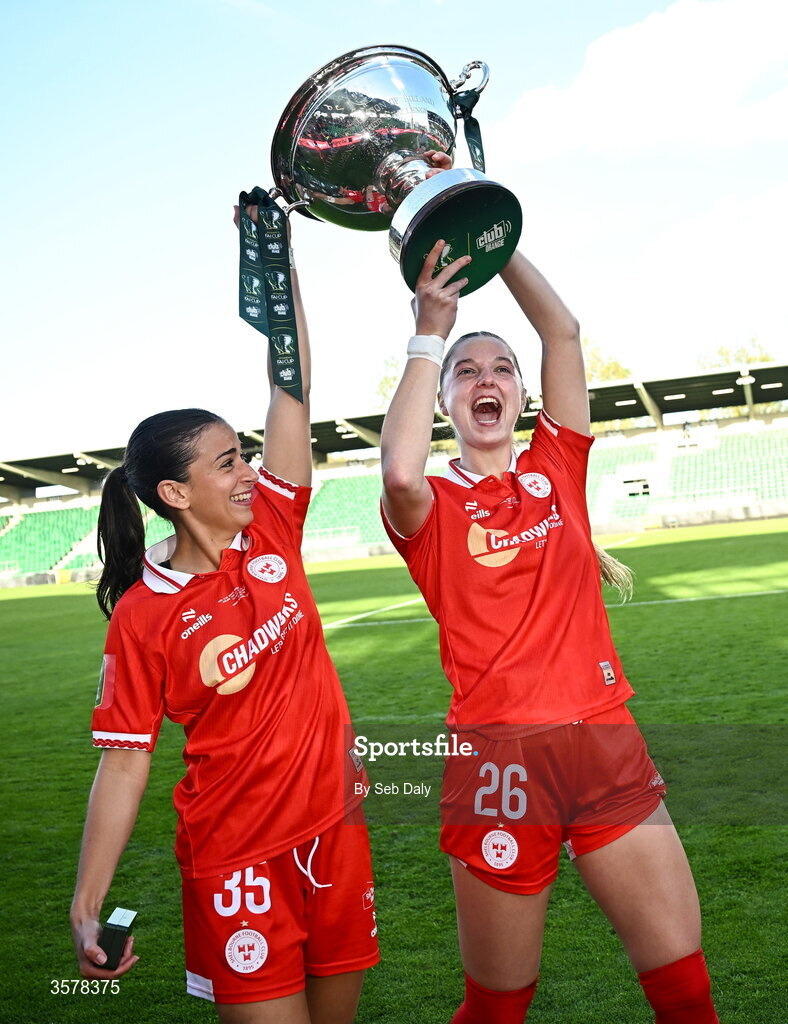27 September 2026; Shelbourne players Olivia Damico, left, and Brie Severns celebrate with the cup after their side's victory in the 2026 Club Orange Women's FAI Cup final between Athlone Town and Shelbourne at Tallaght Stadium in Dublin. Photo by Seb Daly/Sportsfile