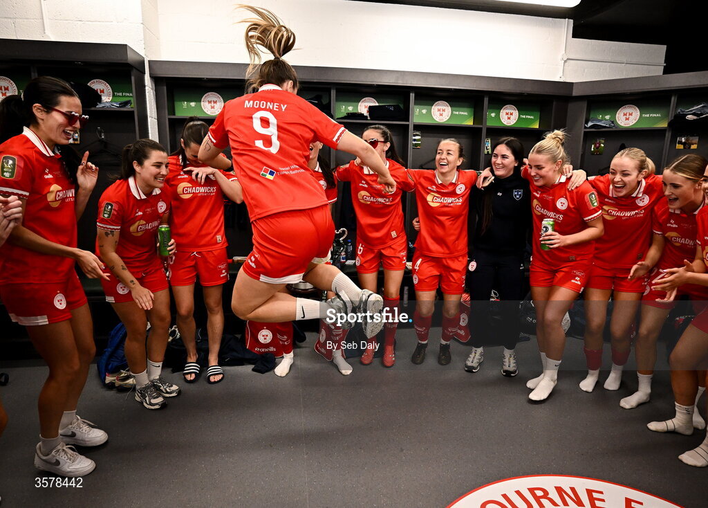 27 September 2026; Kate Mooney of Shelbourne, 9, and teammates celebrate in the dressing room after their side's victory in the 2026 Club Orange Women's FAI Cup final between Athlone Town and Shelbourne at Tallaght Stadium in Dublin. Photo by Seb Daly/Sportsfile