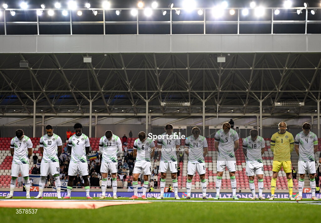 27 September 2026; The Republic of Ireland team, wearing black armbands in recognition for all the lives lost in the conflict in Gaza, bow their heads during the Israeli national anthem before the UEFA Nations League B match between Israel and the Republic of Ireland at Nagyerdei Stadion in Debrecen, Hungary. Photo by Stephen McCarthy/Sportsfile