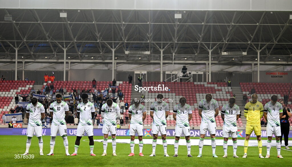 27 September 2026; The Republic of Ireland team, wearing black armbands in recognition for all the lives lost in the conflict in Gaza, bow their heads during the Israeli national anthem before the UEFA Nations League B match between Israel and the Republic of Ireland at Nagyerdei Stadion in Debrecen, Hungary. Photo by Stephen McCarthy/Sportsfile