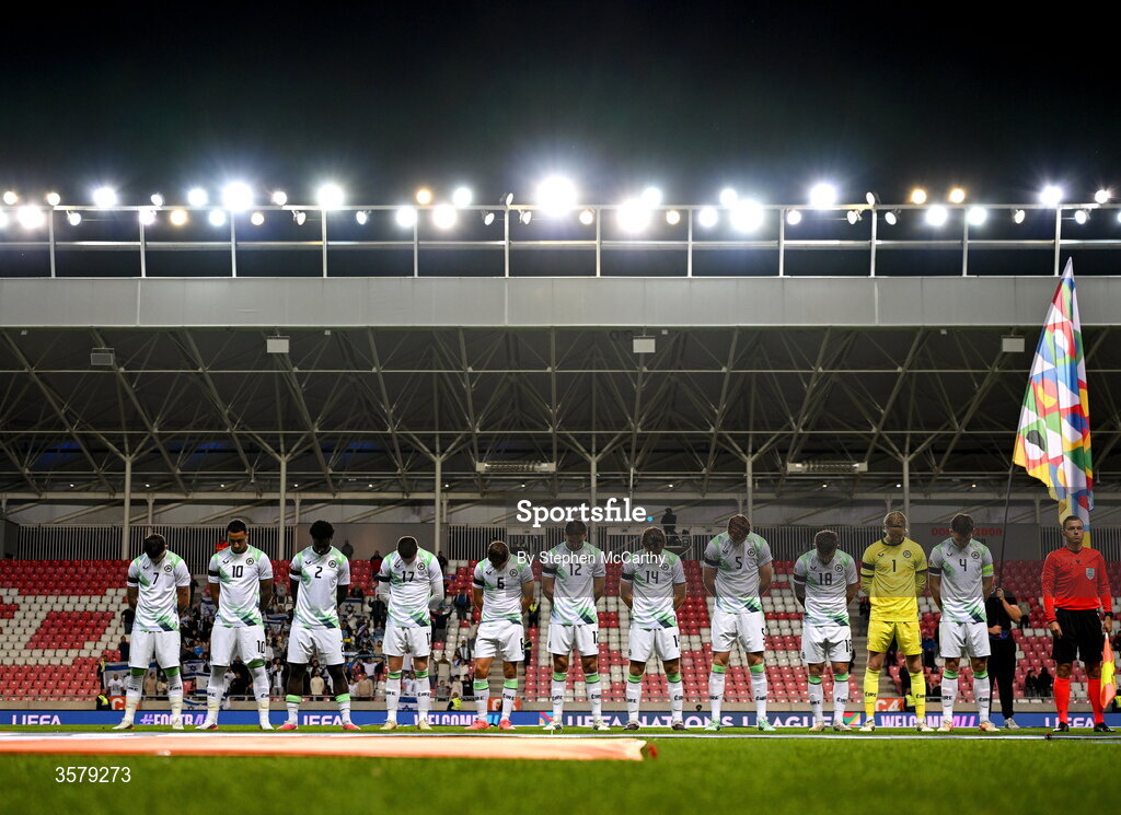 27 September 2026; The Republic of Ireland team, from left, Troy Parrott, Adam Idah, James Abankwah, Jack Moylan, Jayson Molumby, Liam Kitching, Conor Coventry, Jake O'Brien, Ryan Manning, goalkeeper Caoimhín Kelleher and captain Dara O'Shea, wearing black armbands in recognition for all the lives lost in the conflict in Gaza, bow their heads during the Israeli national anthem before the UEFA Nations League B match between Israel and the Republic of Ireland at Nagyerdei Stadion in Debrecen, Hungary.  Photo by Stephen McCarthy/Sportsfile