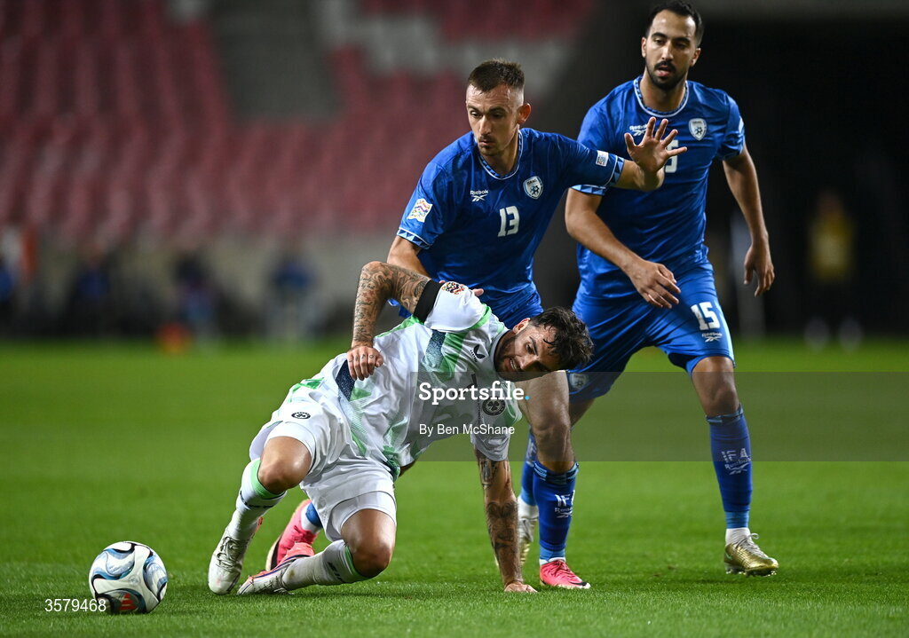 27 September 2026; Troy Parrott of Republic of Ireland is tackled by Nikita Stoinov, centre, and Eliel Peretz or Israel during the UEFA Nations League B match between Israel and the Republic of Ireland at Nagyerdei Stadion in Debrecen, Hungary. Photo by Ben McShane/Sportsfile
