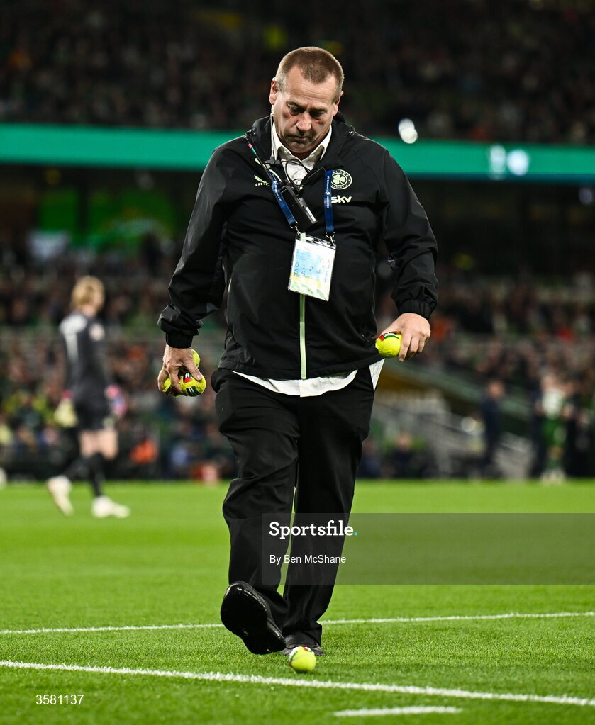 1 October 2026; A member of security clears tennis balls, which were thrown onto the pitch in protest, during the UEFA Nations League B match between the Republic of Ireland and Austria at the Aviva Stadium in Dublin. Photo by Ben McShane/Sportsfile