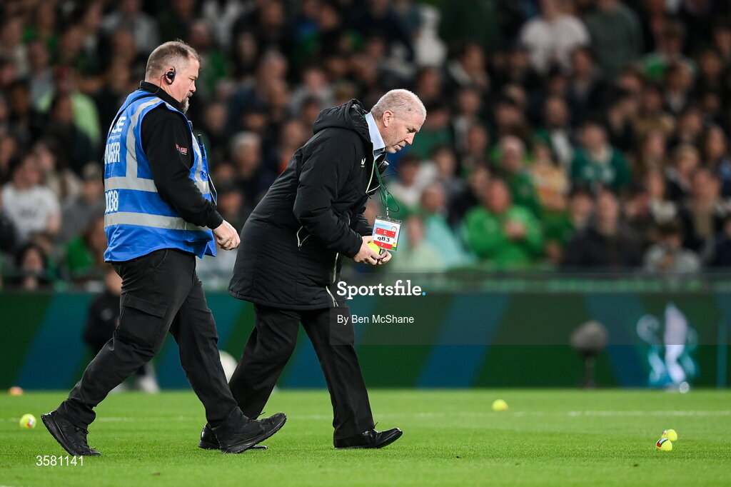 1 October 2026; Security personnel clear tennis balls, which were thrown onto the pitch in protest, during the UEFA Nations League B match between the Republic of Ireland and Austria at the Aviva Stadium in Dublin. Photo by Ben McShane/Sportsfile