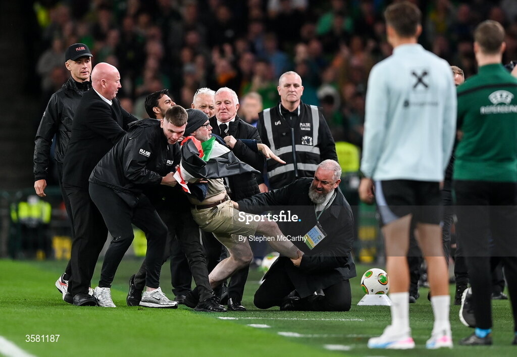 1 October 2026; A protestor is removed from the pitch during the UEFA Nations League B match between the Republic of Ireland and Austria at the Aviva Stadium in Dublin. Photo by Stephen McCarthy/Sportsfile
