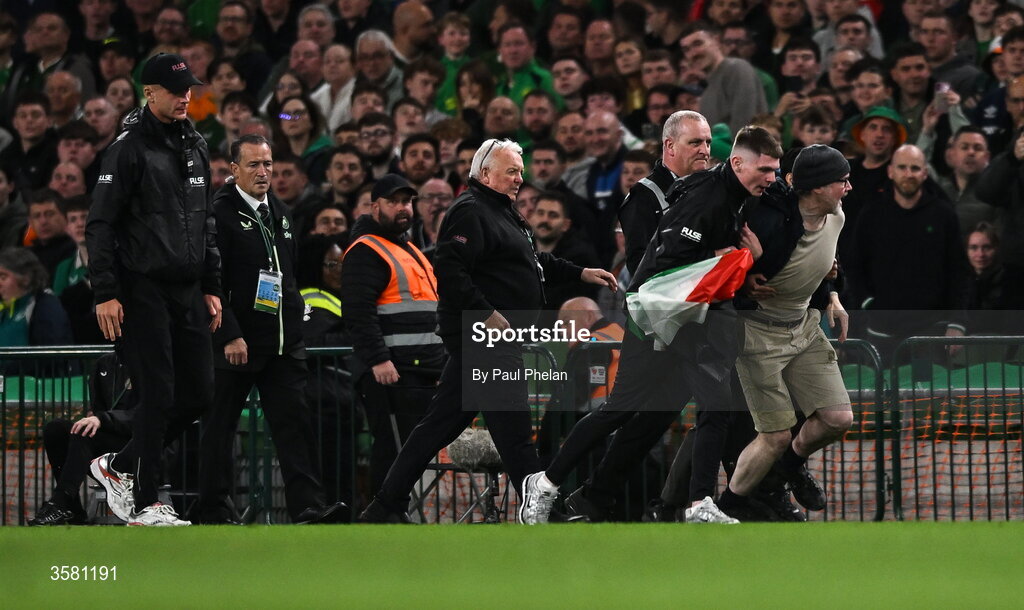 1 October 2026; A protestor is removed from the pitch during the UEFA Nations League B match between the Republic of Ireland and Austria at the Aviva Stadium in Dublin. Photo by Paul Phelan/Sportsfile
