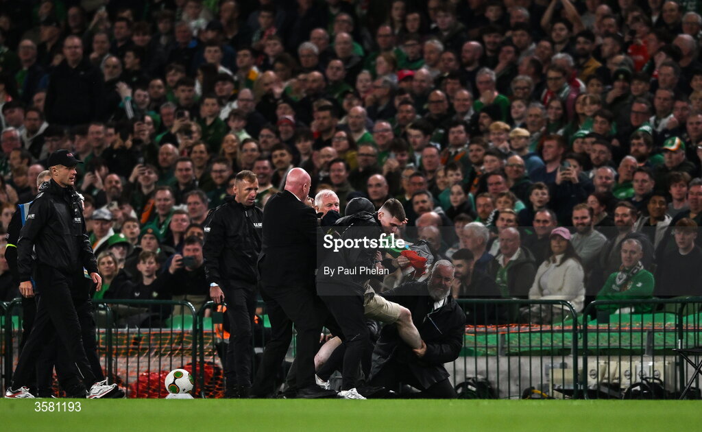 1 October 2026; A protestor is removed from the pitch during the UEFA Nations League B match between the Republic of Ireland and Austria at the Aviva Stadium in Dublin. Photo by Paul Phelan/Sportsfile
