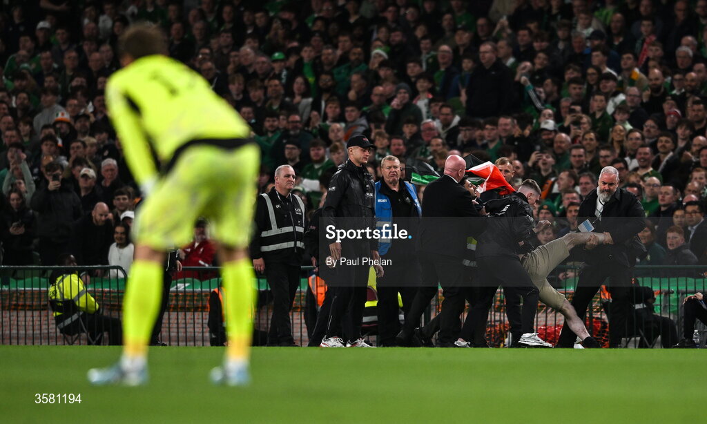 1 October 2026; A protestor is removed from the pitch during the UEFA Nations League B match between the Republic of Ireland and Austria at the Aviva Stadium in Dublin. Photo by Paul Phelan/Sportsfile