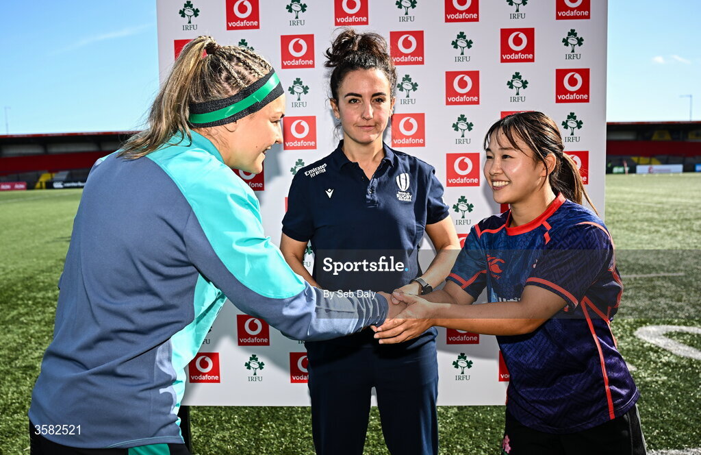 3 October 2026; Ireland captain Erin King, left, and Japan captain Moe Tsukui, shake hands, watched by referee Clara Munarini, before the International Women's Rugby fixture between Ireland and Japan at Virgin Media Park in Cork. Photo by Seb Daly/Sportsfile