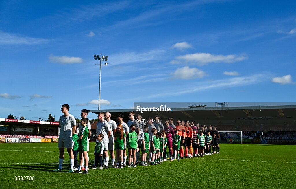 3 October 2026; Players stand for the playing of Amhrán na bhFiann before the FAI Junior Cup final between Coachford and Evergreen at Munster FA Turner's Cross Park in Cork. Photo by Tyler Miller/Sportsfile