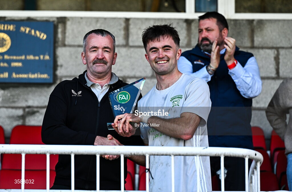 3 October 2026; Cialan O'Sullivan of Coachford is presented with the player of the match award by Munster FA Chairperson John Buckley after the FAI Junior Cup final between Coachford and Evergreen at Munster FA Turner's Cross Park in Cork. Photo by Tyler Miller/Sportsfile