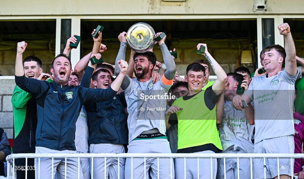 3 October 2026; Coachford captain Mark Murphy lifts the trophy alongside teammates after the FAI Junior Cup final between Coachford and Evergreen at Munster FA Turner's Cross Park in Cork. Photo by Tyler Miller/Sportsfile