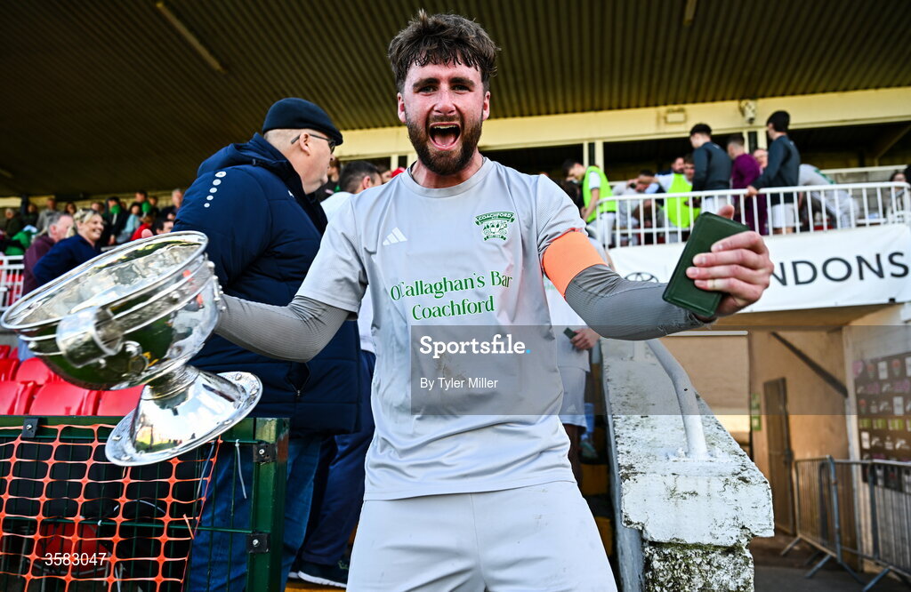 3 October 2026; Coachford captain Mark Murphy celebrates with the trophy after the FAI Junior Cup final between Coachford and Evergreen at Munster FA Turner's Cross Park in Cork. Photo by Tyler Miller/Sportsfile