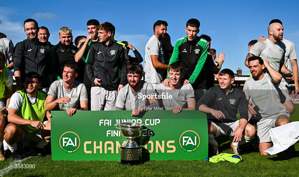 3 October 2026; Coachford players and staff celebrate with the trophy after the FAI Junior Cup final between Coachford and Evergreen at Munster FA Turner's Cross Park in Cork. Photo by Tyler Miller/Sportsfile