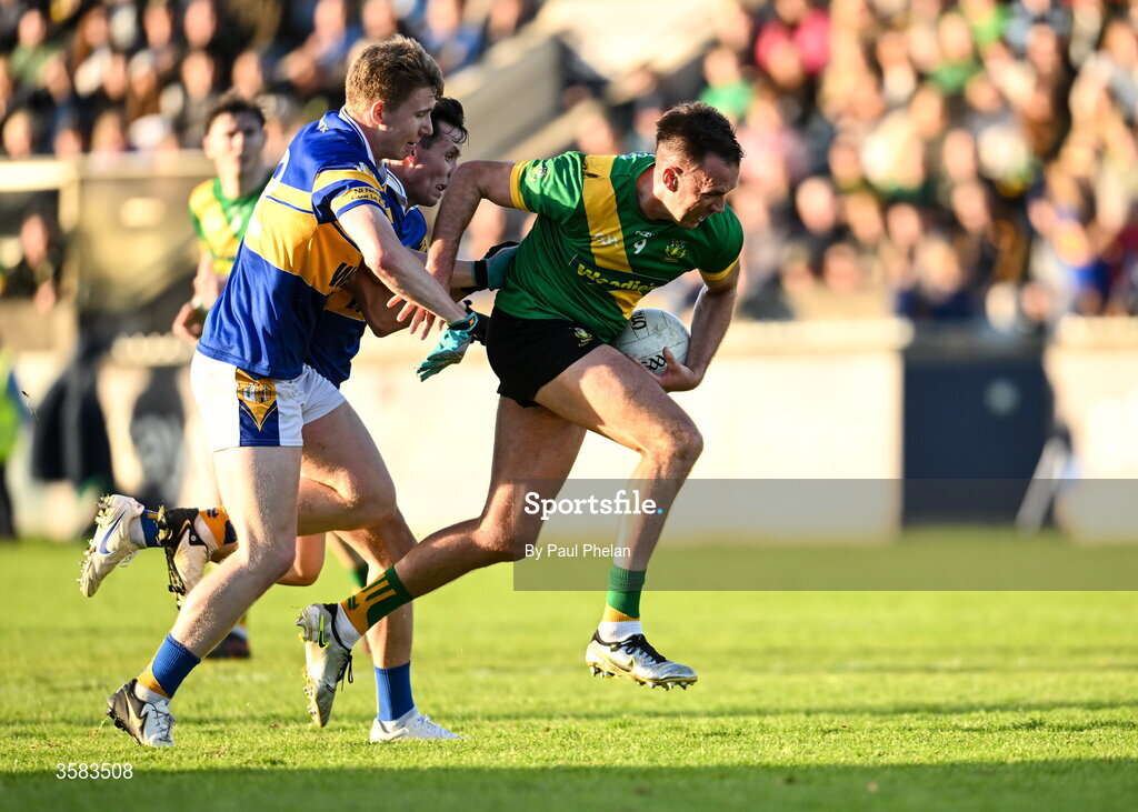 3 October 2026; Ryan Deegan of Thomas Davis in action against Eoin Walsh and Ben Galvin of Castleknock during the Dublin County Senior Club Football Championship semi-final match between Thomas Davis and Castleknock at Parnell Park in Dublin. Photo by Paul Phelan/Sportsfile
