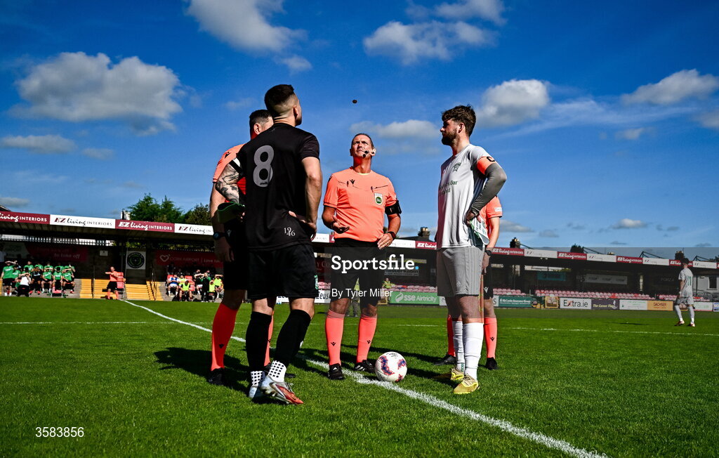 3 October 2026; Referee Brian Higgins performs the cointoss with team captains Michael Drennan of Evergreen and Mark Murphy of Coachford during the FAI Junior Cup final between Coachford and Evergreen at Munster FA Turner's Cross Park in Cork. Photo by Tyler Miller/Sportsfile